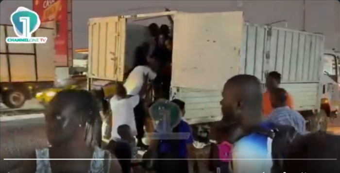 Watch Commuters stuck at Achimota Old Station join a cargo truck turned into a makeshift bus