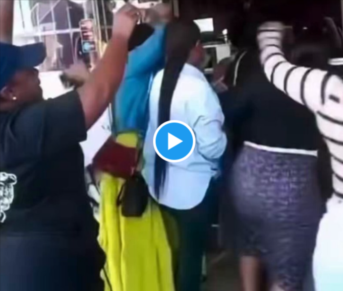South African women celebrate after taking over a salon owned by a Ghanaian