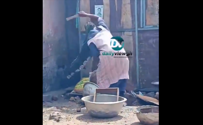 Woman shockingly beats young girl with a piece of firewood