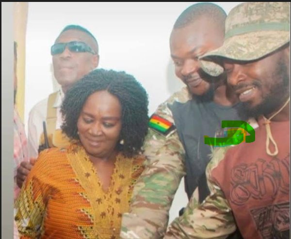The suspect Musah Attah cutting a cake with the Vice President